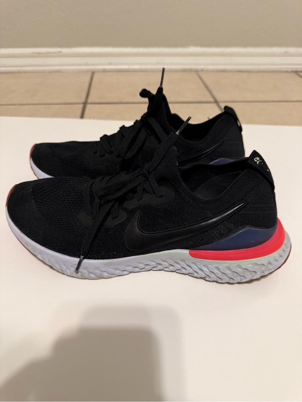 Nike men’s React Black Running Shoes with Coral Accent